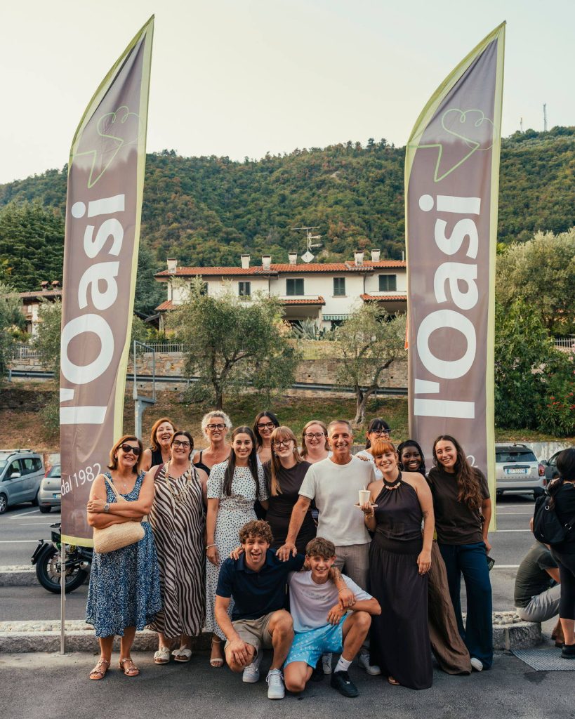 Famiglia e staff dell’Oasi davanti alle bandiere, il giorno dell’apertura di Sarnico